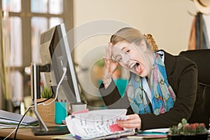Stressed Professional Woman Screaming at her desk
