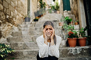 Stressed sad woman in bad mood overthinking problems, having a headache.Mental health problems, depression, anxiety, emotional