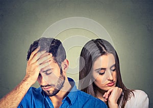 Stressed sad young couple man and woman looking down