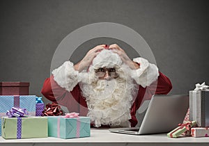 Stressed Santa connecting with his laptop