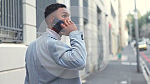 Stressed, scared and worried businessman talking on phone and checking for privacy, surveillance or tracking in a city