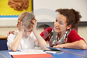 Stressed Schoolboy Studying In Classroom