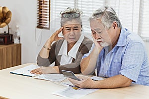 Stressed senior elderly couple conclict of credit card bills or bebt of expense in shopping. Lover financial risk or crisis and