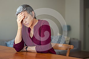 Stressed senior woman at home