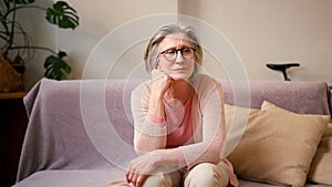 Stressed senior woman at home with internet banking debt, problem and crisis. Retirement, anxiety and elderly person in