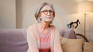 Stressed senior woman at home with internet banking debt, problem and crisis. Retirement, anxiety and elderly person in