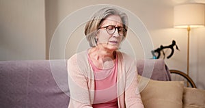 Stressed senior woman at home with internet banking debt, problem and crisis. Retirement, anxiety and elderly person in
