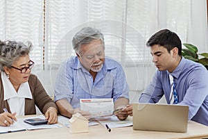 Stressed and serious retired Asian senior eldery couple consult with personal financial advisor or real estate agent about debt