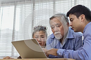 Stressed and serious retired Asian senior eldery couple consult with personal financial advisor or real estate agent about debt