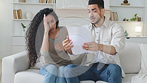 Stressed spaniard hispanic couple receives letter notice of divorce papers documents feels shocked about unpaid taxes