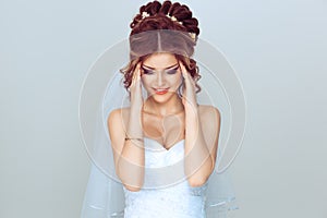 Stressed spouse. Portrait of a young woman girl in wedding dress having stress a headache, migraine, closeup.  light blue