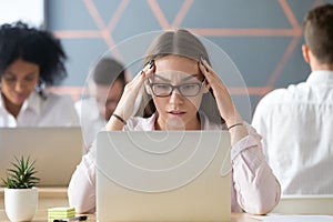 Stressed student concerned about hard online task looking at lap