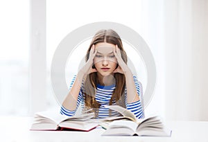 Stressed student girl with books