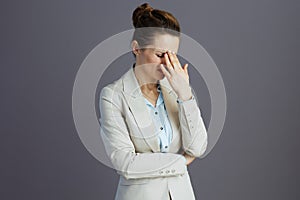 stressed stylish woman worker in light business suit