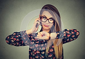 Stressed surprised business woman looking at wrist watch, running late for meeting