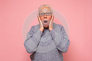 Stressed surprised old mature woman looking at camera worried about facial wrinkles