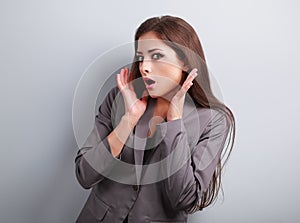 Stressed surprising business woman in suit with hand near face l