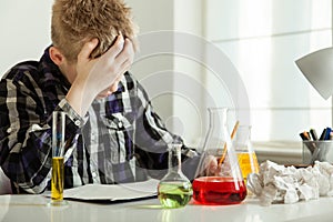 Stressed Teenage Boy Doing Chemistry Homework