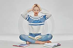 Stressed teenage student girl with books