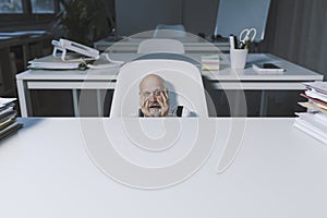 Stressed terrified businessman working in the office