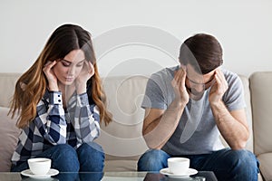 Stressed tired couple massaging temples got flu symptoms strong headache