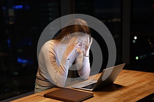 Stressed tired female employee feel headache caused by work overtime