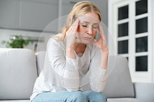 Stressed, tired woman with closed eyes feeling strong headache pain