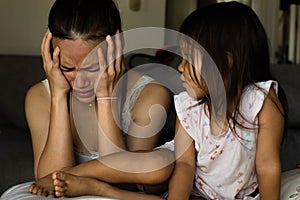 Stressed unhappy mother at home with her child