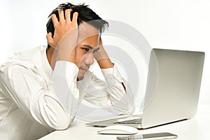 Stressed and upset business man working on a computer