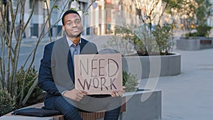 Stressed upset sad desperate hopeless ethnic student holding poster need work. African American businessman entrepreneur