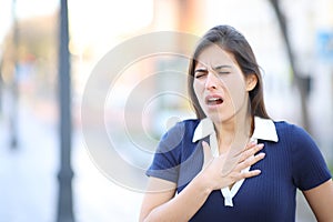 Stressed woman choking in the street