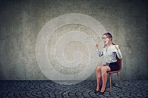 Stressed woman company employee sitting on a chair screaming in desperation