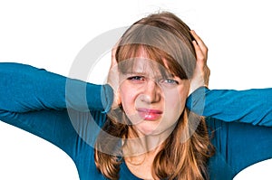 Stressed woman covering her ears to protect from loud noise