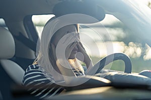 Stressed woman cry in car. Middle age lady driver hide face in hands afraid to drive after accident