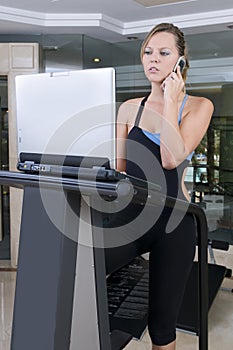 Stressed woman doing exercise and working lap top