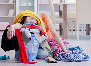 Stressed woman doing laundry at home