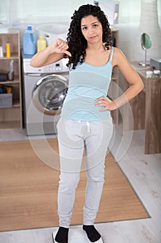 stressed woman doing laundry at home