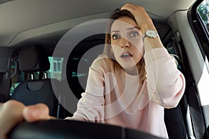 Stressed woman in driver`s seat of modern car