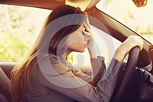 Stressed woman driver sitting inside her car photo