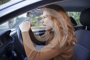 Stressed woman feeling angry and driving car