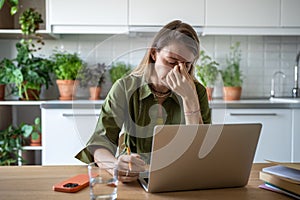 Stressed woman feeling exhausted of overtime work, realizing failure to keep to task deadline