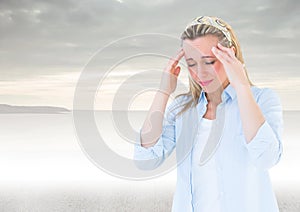 Stressed woman headache in front of sea