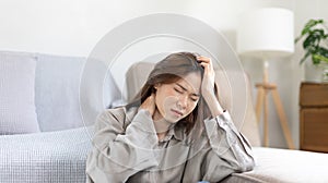 Stressed woman holding her temples with severe problems in her life