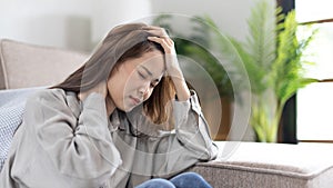 Stressed woman holding her temples with severe problems in her life