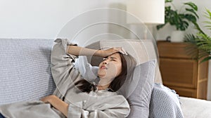 Stressed woman holding her temples with severe problems in her life