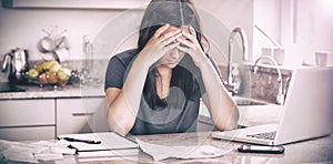 Stressed woman looking down at bills