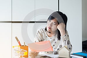 Stressed woman managing debt,House bills with taxes and bank account balance