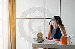 Stressed woman managing debt,House bills with taxes and bank account balance,Financial Management Concepts photo