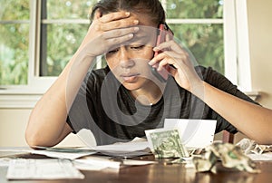 A stressed woman with no money looking at her credit card bills and monthly payments. Financial crisis debt