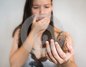 A stressed woman's hair falling out. Damaged hair